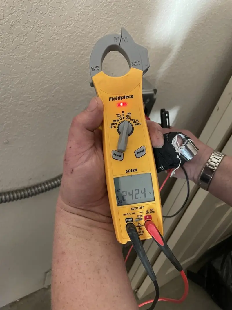 Voltage testing with clamp meter during Ceiling Fan Installation in Gibson